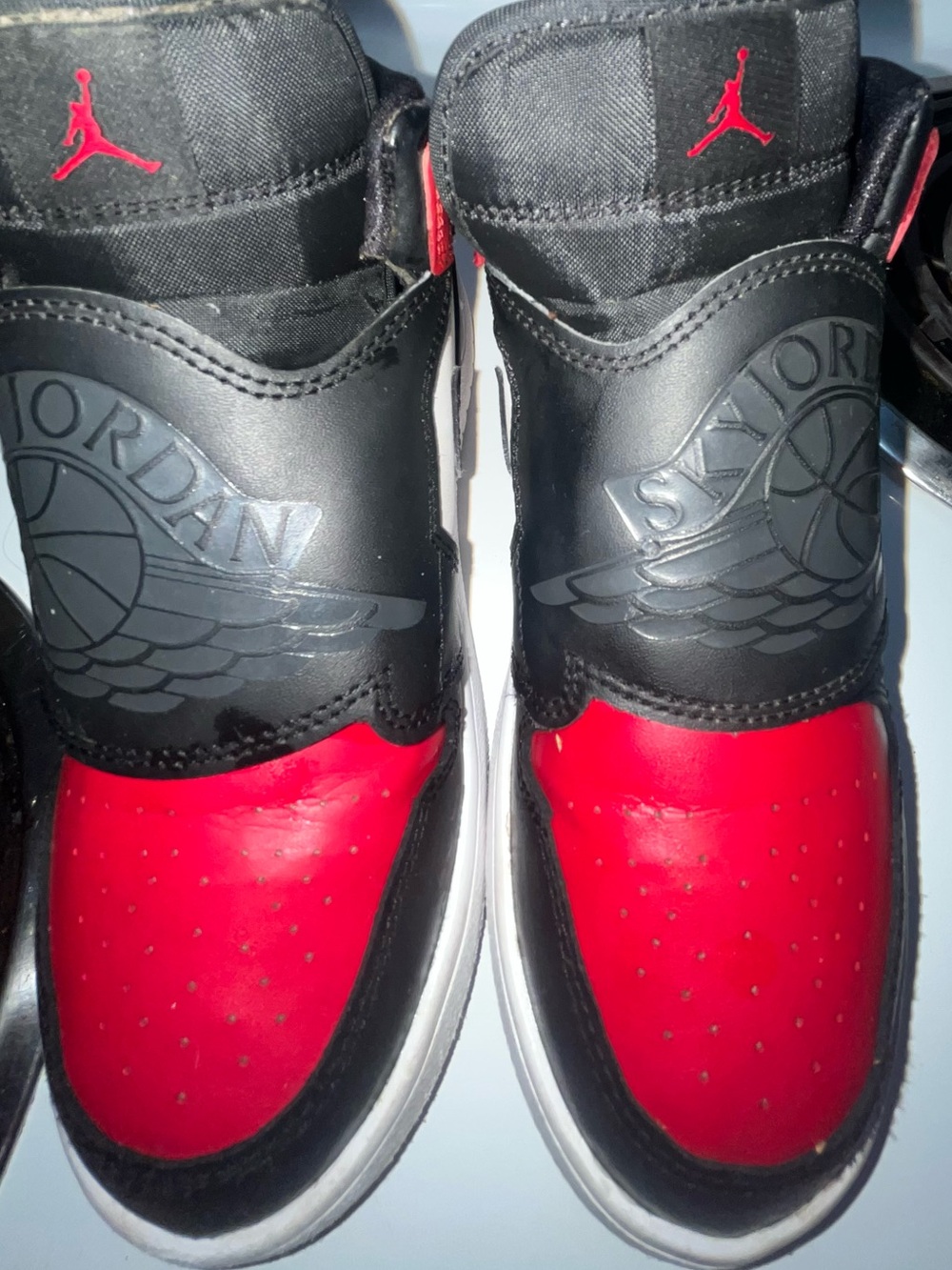 Nike Sky Jordan 1 PS "Bred Toe" sneakers in black and varsity red.